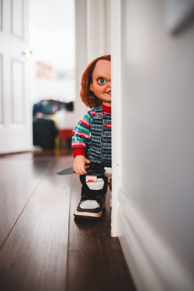 doll with knife in trendy gumshoe at home